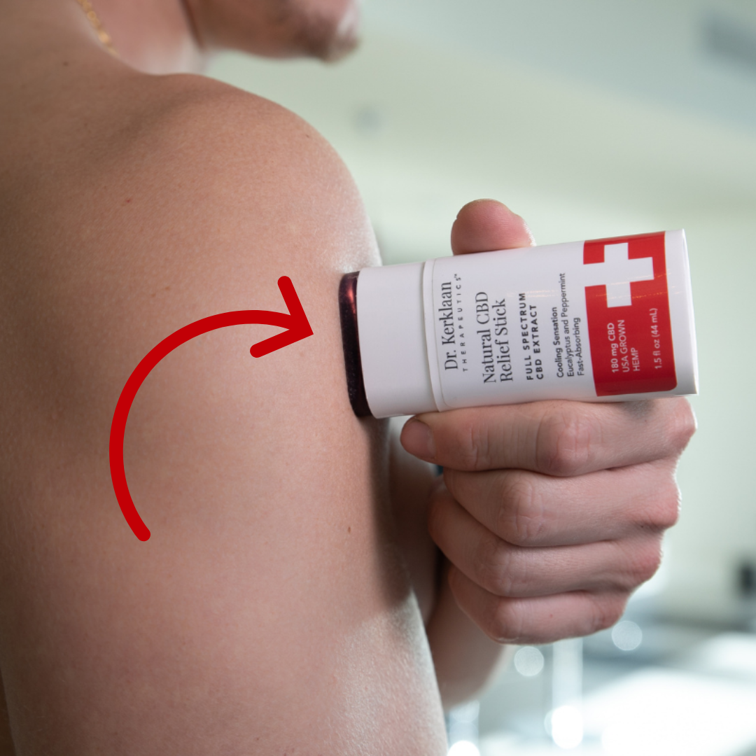 Close-up of a man applying a CBD relief stick to his upper arm, highlighting targeted muscle recovery with a red motion arrow.