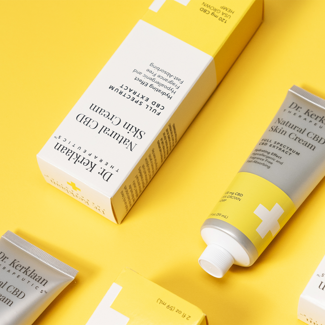 Dr. Kerklaan Natural CBD Skin Cream in a sleek yellow and white tube with matching packaging, displayed on a vibrant yellow background. The full-spectrum CBD cream is designed for hydration, soothing relief, and fast absorption.